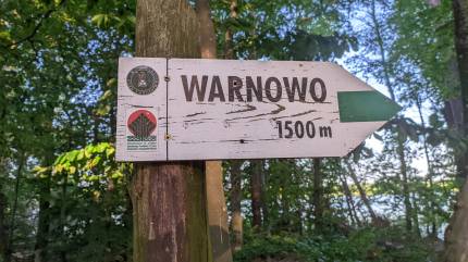 Kierunkowskaz Warnowo obok ławeczek na początku półwyspu Jeziora Czajcze. Fot. Łukasz Grzejszczak Mojeurlopy.pl
